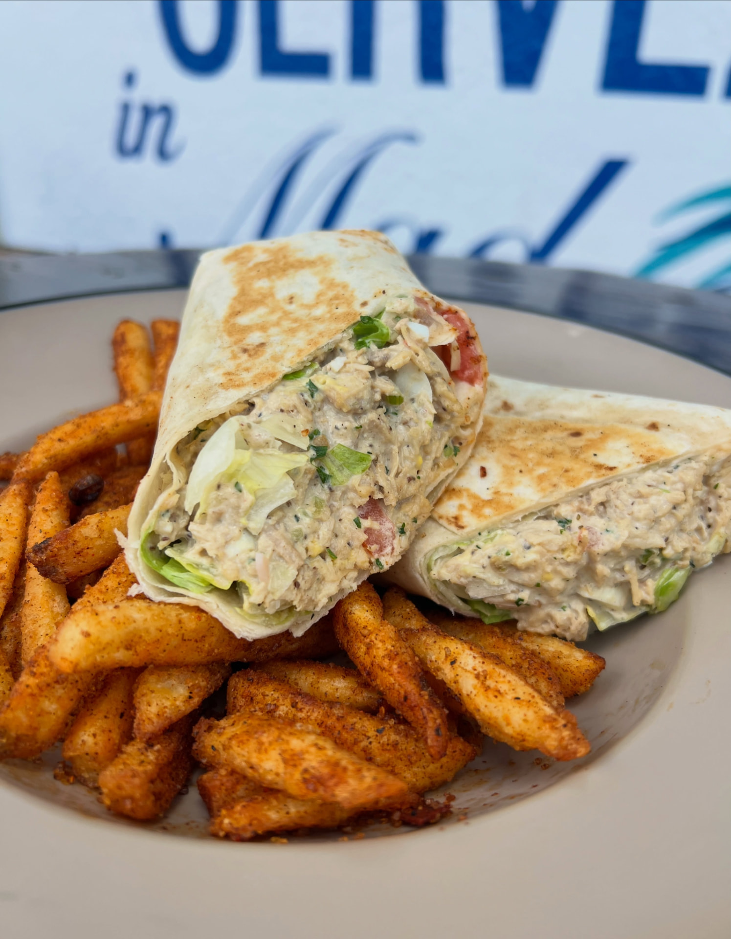 Chicken salad wrap with seasoned fries at Saltwater Hippie